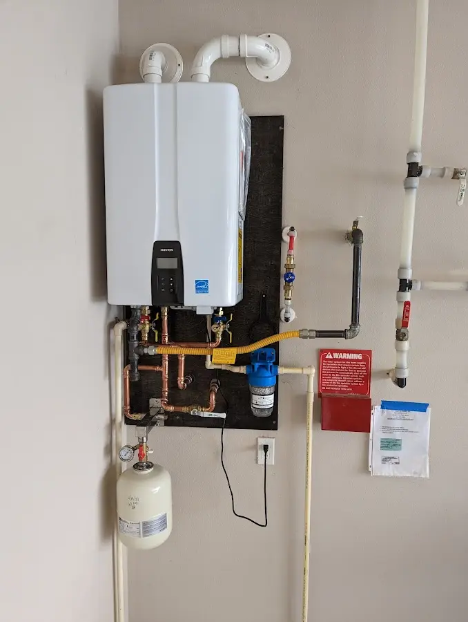 Professional plumber installing copper piping in a San Fernando home